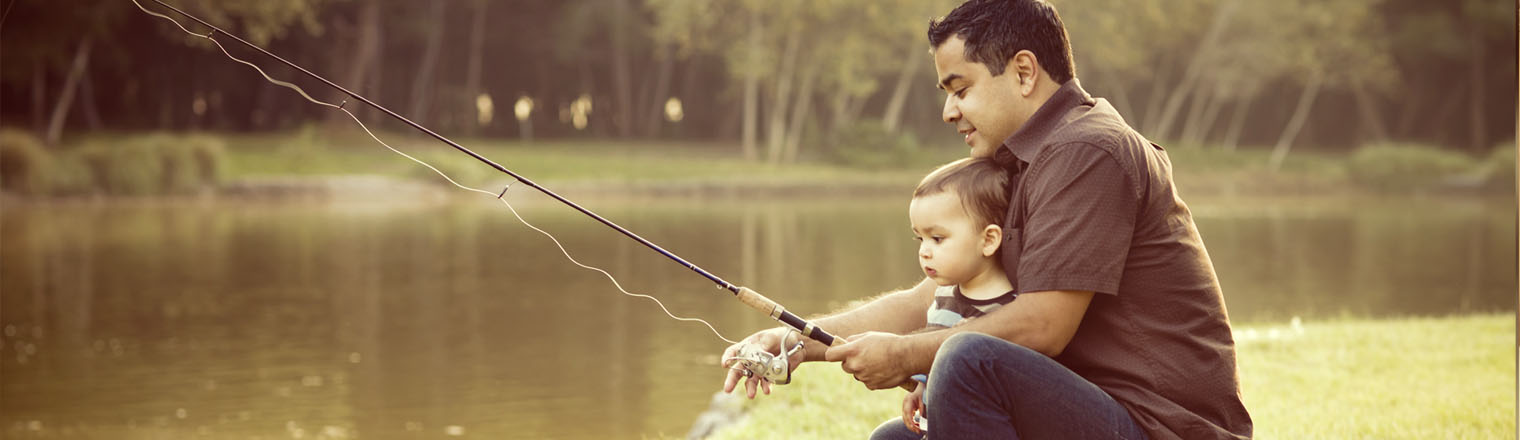 father fishing with toddler